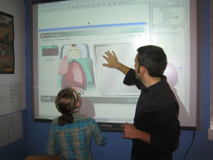 Picture of teacher and student using smartboard